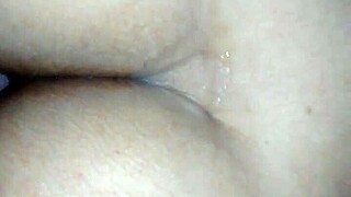 Brazilian couple enjoys intimate moments together in cozy setting.