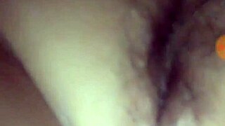 A young teen indulges in self-pleasure with her hands.