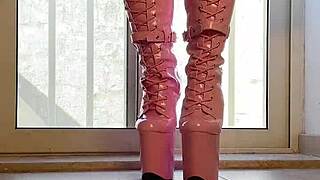 Walking tall in pink boots for erotic domination fantasy.