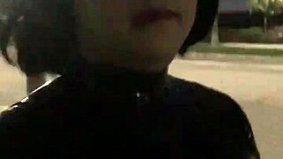 Crossdresser in latex struts outdoors with a vibrator buzzing in public.