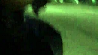 Crossdresser in latex struts outdoors with a vibrator buzzing in public.