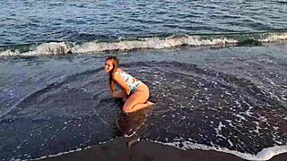 watch this horny teen on the beach, showing her big ass and pussy in public?