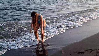 watch this horny teen on the beach, showing her big ass and pussy in public?