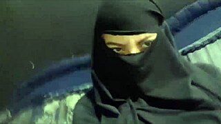 Arab amateur milf in hijab flashes big tits and squirts from creamy pussy. Her niqab dress hides nothing during this steamy show.
