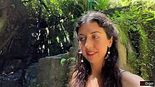 in the public locker room, she gets cum on her face, then walks to the waterfall with it