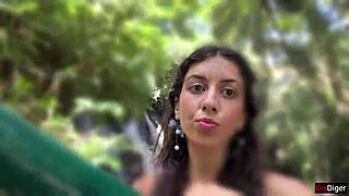 in the public locker room, she gets cum on her face, then walks to the waterfall with it