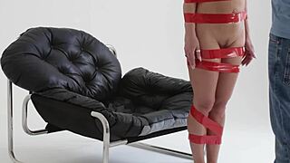 blonde playboy girl gets tied up with red tape backstage.