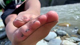 goddess in tan nylons shows her cute nylon soles and toes on the riverside