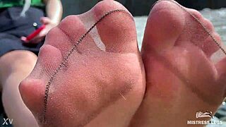 goddess in tan nylons shows her cute nylon soles and toes on the riverside