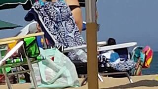 candid on this little 18+ slut at the beach in bikini