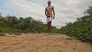 African guy gets handjob and cums on the beach