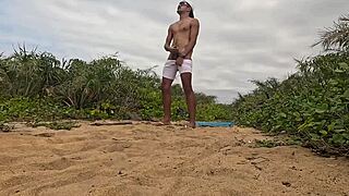 African guy gets handjob and cums on the beach