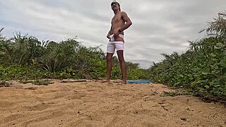 African guy gets handjob and cums on the beach