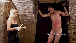 The cruel blonde milf whips the guy's cock brutally in this bdsm session. Extreme pain for him.