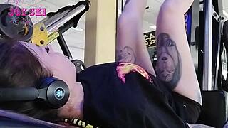 this alternative girl with tattoos stretches at the gym