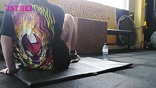 this alternative girl with tattoos stretches at the gym