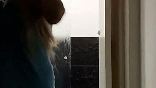 Blonde showers and changes clothes unaware until spotting the hidden watcher—what unfolds?